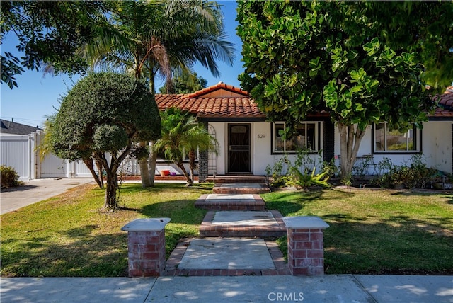 mediterranean / spanish house featuring a front lawn