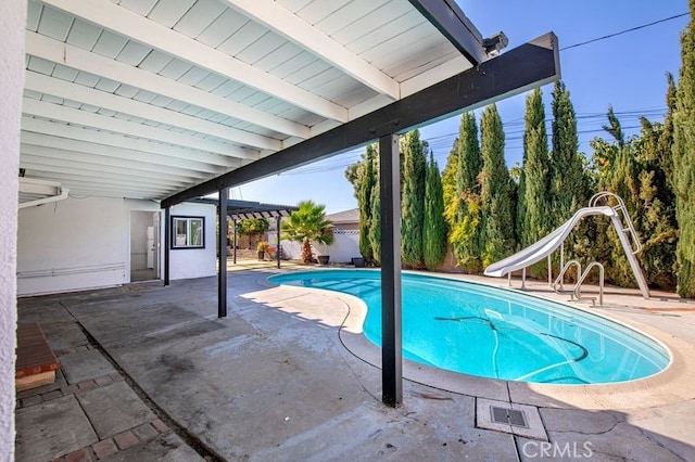 view of pool featuring a patio area and a water slide