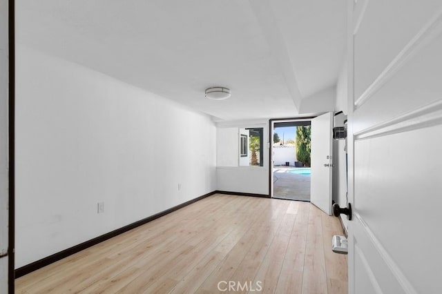 empty room with light hardwood / wood-style flooring