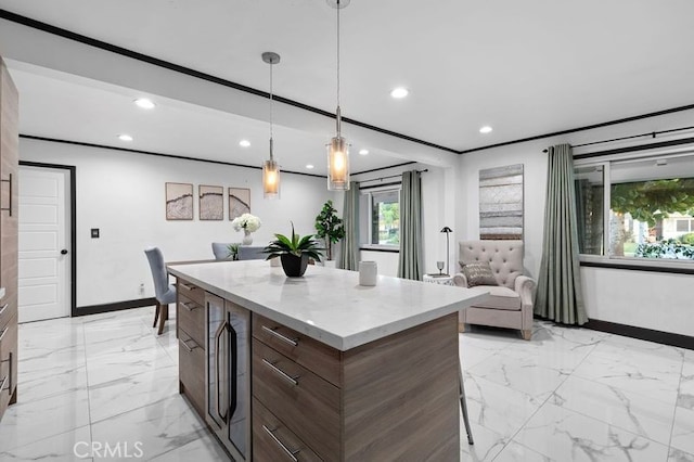 kitchen with dark brown cabinets, a center island, and hanging light fixtures