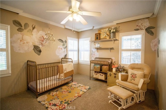 carpeted bedroom featuring ceiling fan, a nursery area, and ornamental molding