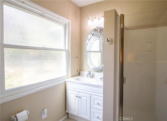 bathroom with vanity, a wealth of natural light, and a shower with shower door