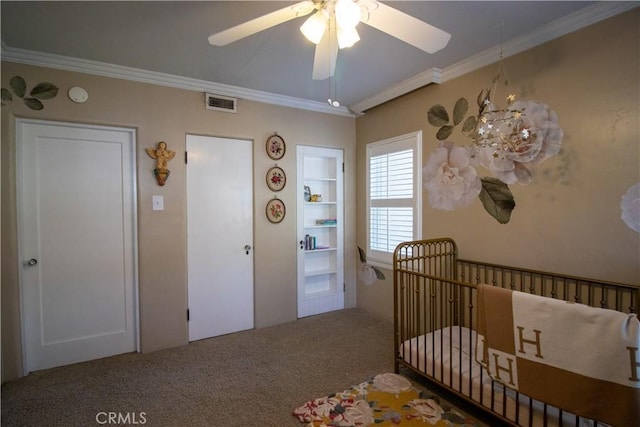 bedroom with carpet, crown molding, ceiling fan, and a nursery area