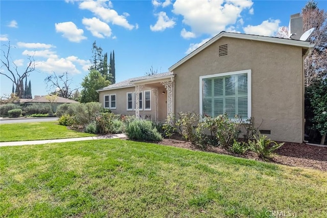 ranch-style house featuring crawl space, stucco siding, a chimney, and a front lawn