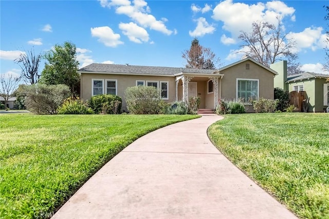 ranch-style house with stucco siding and a front yard