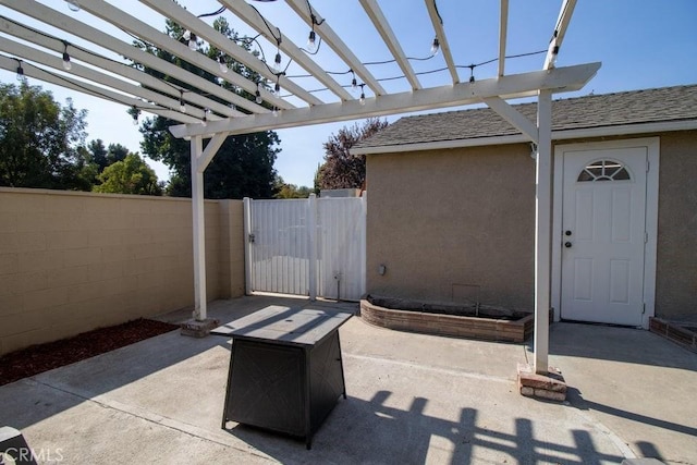 view of patio / terrace with fence, a pergola, and a gate