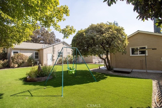 view of jungle gym with a yard and fence