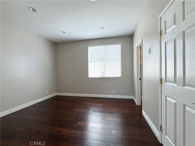 unfurnished room featuring dark hardwood / wood-style floors