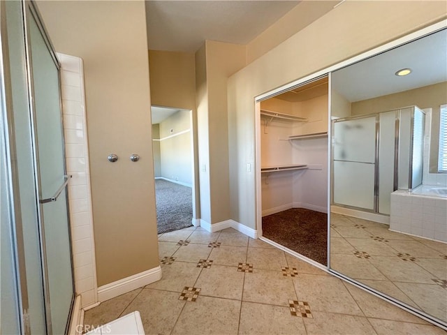 bathroom with tile patterned flooring and independent shower and bath