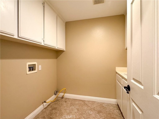 clothes washing area with cabinets, hookup for a washing machine, light tile patterned floors, and gas dryer hookup