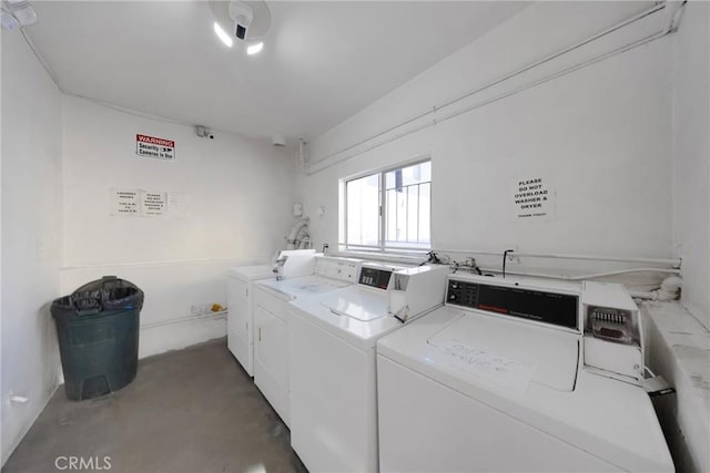 clothes washing area with washing machine and clothes dryer