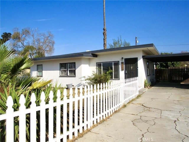 view of front of property featuring a carport