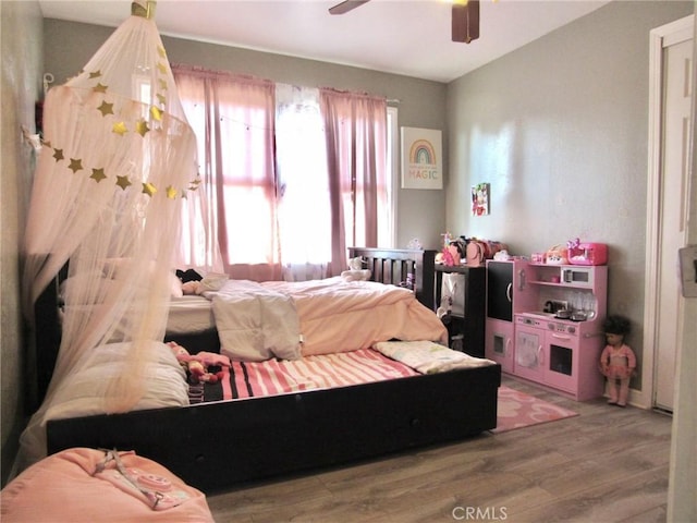 bedroom with ceiling fan and hardwood / wood-style floors