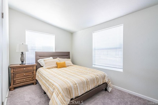 carpeted bedroom with vaulted ceiling