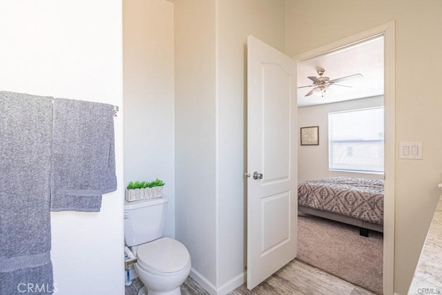 bathroom featuring ceiling fan and toilet