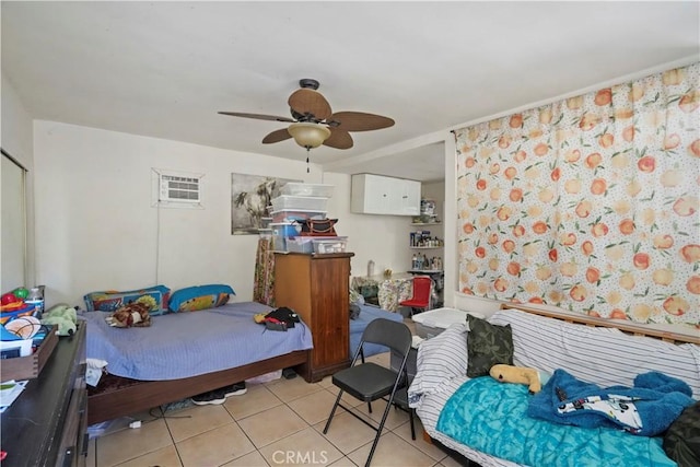 tiled bedroom featuring ceiling fan and a wall mounted air conditioner