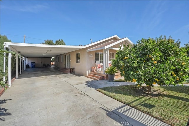 view of front facade with a front yard and a carport