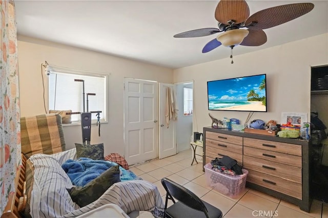 interior space with ceiling fan and light tile patterned flooring