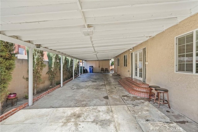 view of patio / terrace featuring a carport and french doors