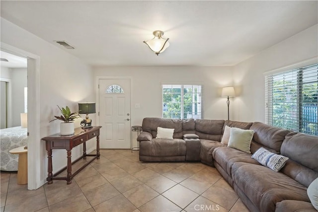 living room with a wealth of natural light and light tile patterned flooring