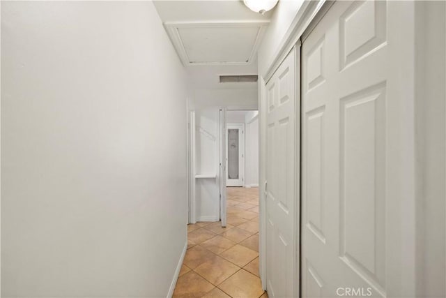 hall featuring light tile patterned floors