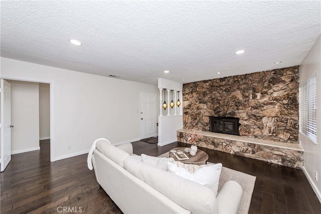 living room with dark hardwood / wood-style flooring and a textured ceiling