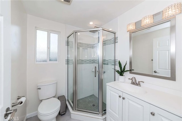 bathroom with vanity, toilet, and a shower with door