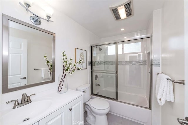 full bathroom featuring tile patterned flooring, vanity, toilet, and bath / shower combo with glass door