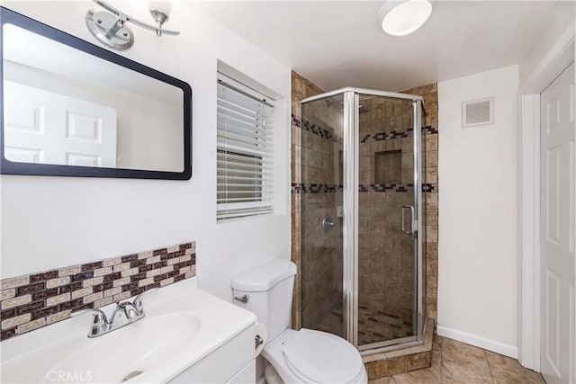 bathroom with an enclosed shower, vanity, toilet, and tile patterned flooring