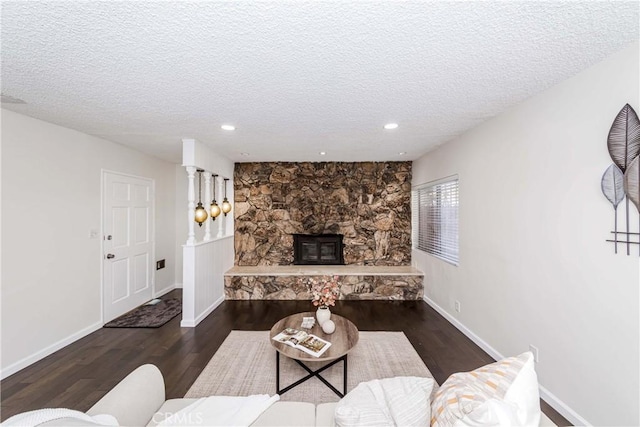 living room featuring a textured ceiling and dark hardwood / wood-style floors