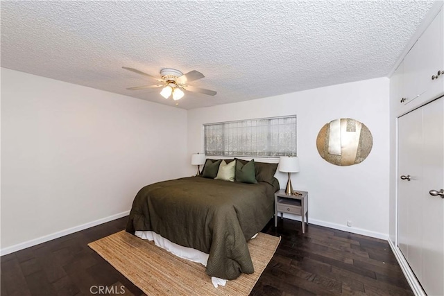 bedroom featuring a textured ceiling, dark hardwood / wood-style flooring, and ceiling fan