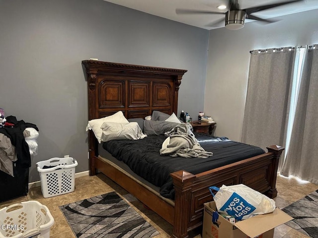 bedroom with ceiling fan and light tile patterned floors