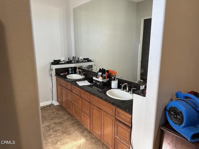 bathroom featuring toilet and vanity