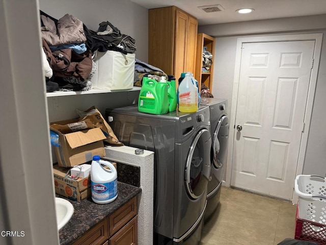 washroom with cabinets and independent washer and dryer