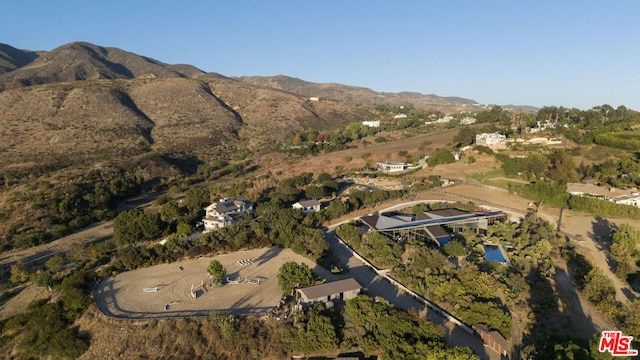 birds eye view of property with a mountain view