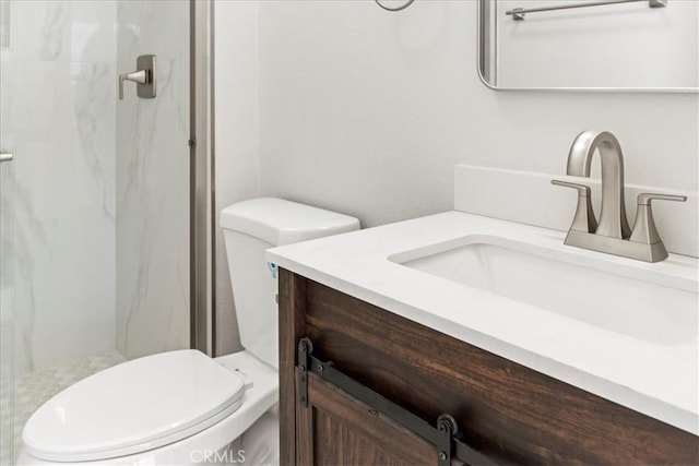 bathroom with a shower, vanity, and toilet