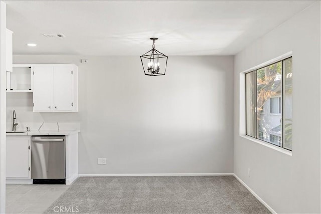 unfurnished dining area featuring light colored carpet, a notable chandelier, and sink