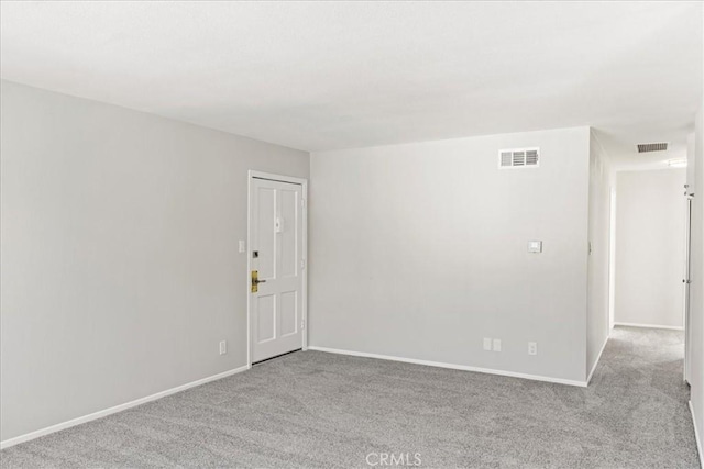 empty room featuring light colored carpet