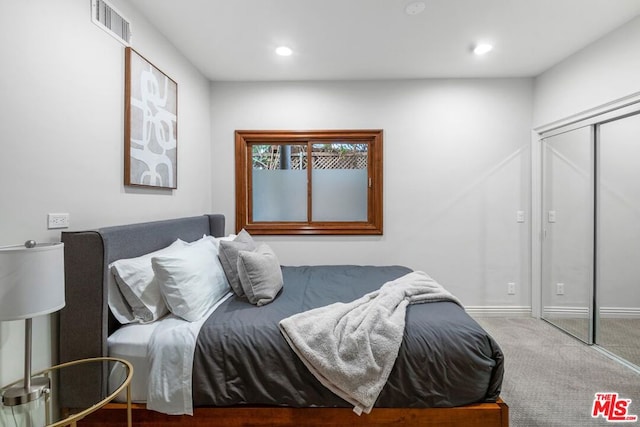 bedroom featuring carpet and a closet