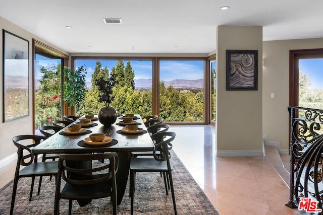 dining space featuring a mountain view and light tile patterned flooring