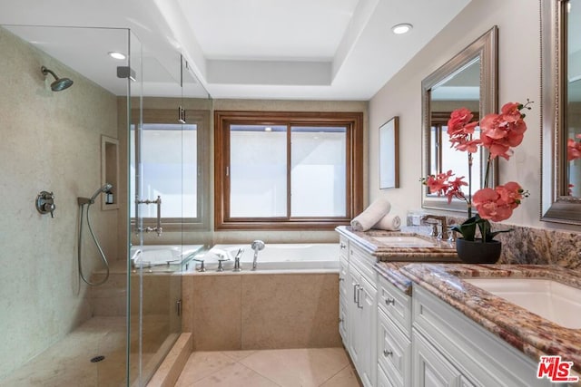 bathroom with tile patterned floors, plenty of natural light, separate shower and tub, and vanity