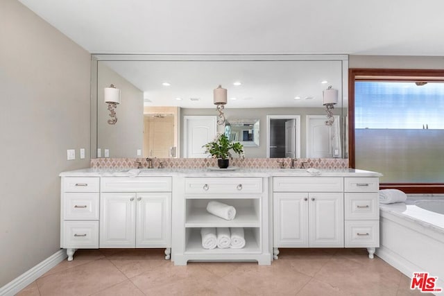 bathroom featuring tile patterned flooring, vanity, and a bathtub