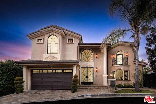 mediterranean / spanish-style home featuring a garage