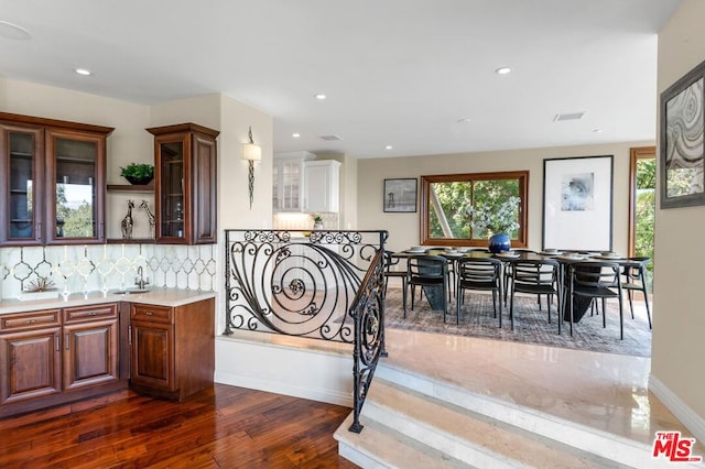 kitchen with decorative backsplash and dark hardwood / wood-style flooring