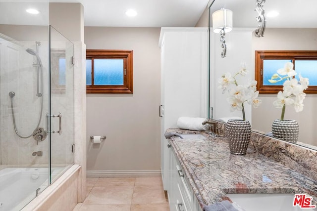 bathroom with vanity, tile patterned floors, and enclosed tub / shower combo