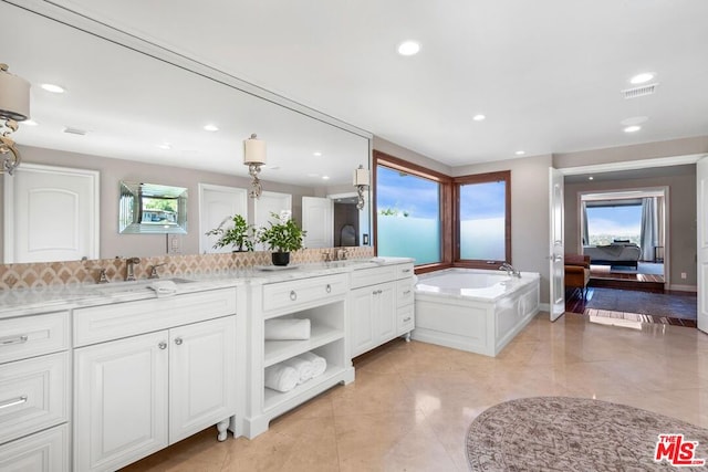 bathroom featuring vanity and a tub to relax in