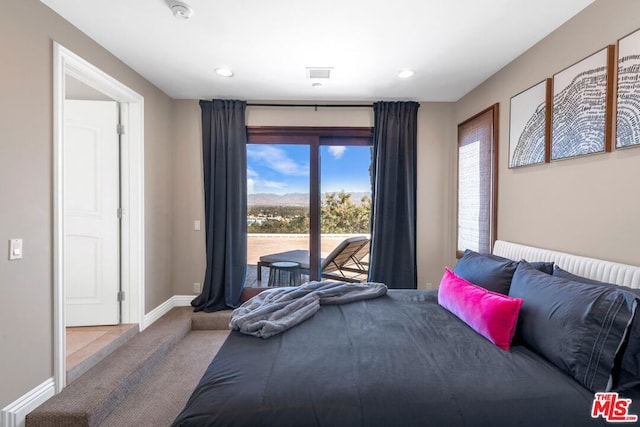 carpeted bedroom featuring access to exterior