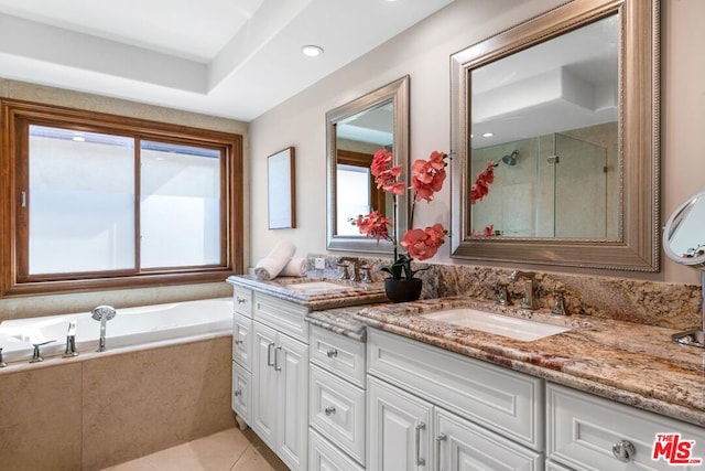 bathroom featuring tile patterned flooring, vanity, and separate shower and tub