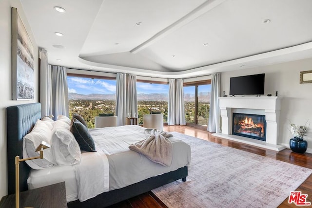 bedroom featuring lofted ceiling with beams and wood-type flooring