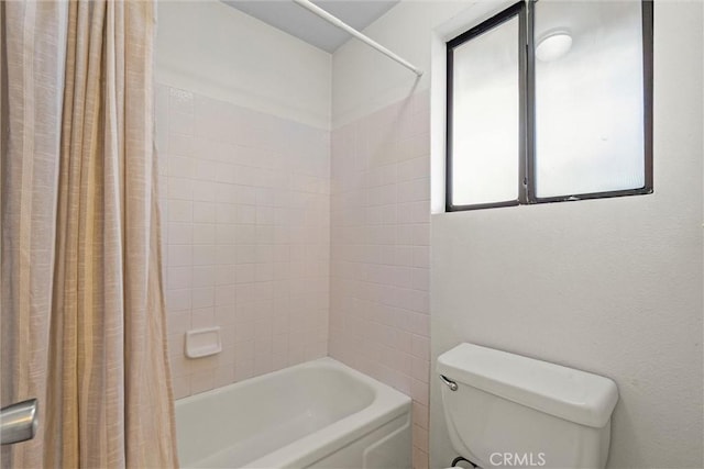 bathroom with shower / bath combination with curtain and toilet